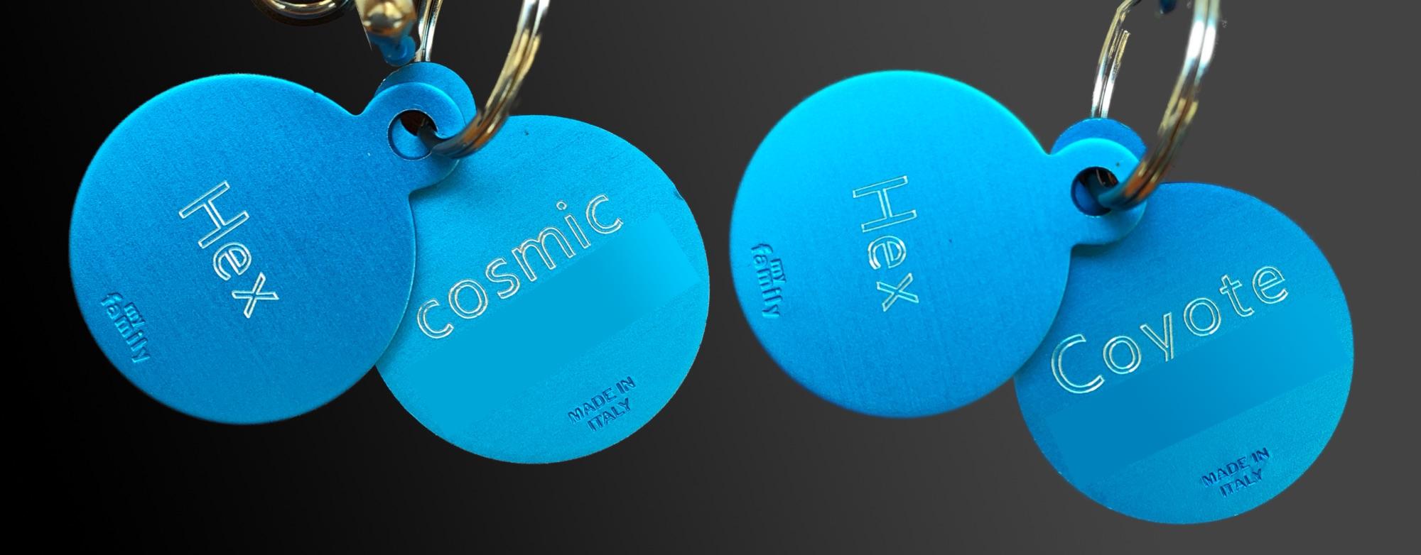 A picture of two sets of collar tags. One has "Hex" on the front and "cosmic" on the back and the other has "Hex" on the front and "Coyote" on the back.
