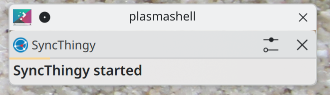 A notification showing that "SyncThingy" has started. The notification has two "X" buttons to close it, one from the notification itself and then one from a native window border.